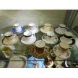 A quantity of decorative coffee cans & saucers inc