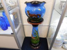 A Torquay pottery jardiniere & stand, crack to jar