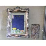 A silver photo frame twinned with a silver condime