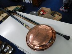 A copper bed pan with chased decor twinned with tw