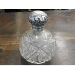 A silver topped scent bottle