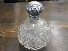 A silver topped scent bottle