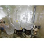 Four crystal decanters twinned with two mugs & a c