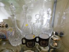 Four crystal decanters twinned with two mugs & a c