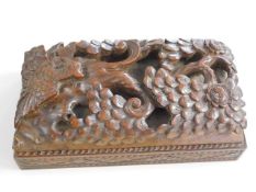 An Oriental style carved hardwood box with sliding