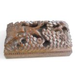 An Oriental style carved hardwood box with sliding