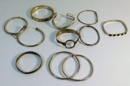 Ten silver & white metal bangles