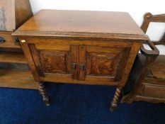 A small oak cabinet with barley twist legs, two do