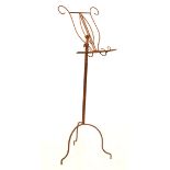 Wrought metal music stand of tubular design on tripod support Condition: