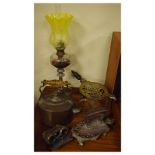 Group of metal wares comprising: paraffin lamp, trivet with turned wooden handle, oval kettle,