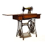 Singer sewing machine within oak cabinet on iron treadle base Condition: