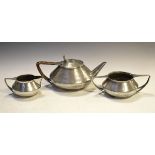 Art Nouveau style Roundhead planished pewter three piece tea service comprising: teapot, milk jug