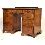 Early 20th Century mahogany kneehole twin pedestal desk, the moulded rectangular top over three