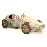 Early to mid 20th Century tin plate pedal car of racing design with steerable front wheels, red