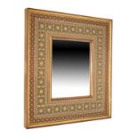 Eastern painted and gilded wall mirror with plain rectangular plate in decorated frame Condition: