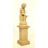 Composition garden ornament modelled as a young boy reading an alphabet book upon pedestal base,