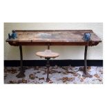 Vintage work bench with elm saddle seat and a vice on cast iron supports Condition: