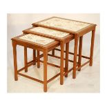 Nest of three 1970's period teak tile-top occasional tables, the largest with six tiles, the smaller