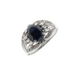 18ct white gold dress ring set large oval sapphire coloured stone with baguette cut diamond border