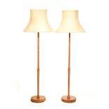 Two 1960's period turned wooden standard lamps, each with shade Condition: