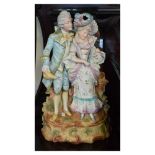 Early 20th Century Continental bisque porcelain figure group modelled as a courting couple, he