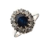 18ct white gold dress ring set central large oval sapphire coloured stone within a diamond border,