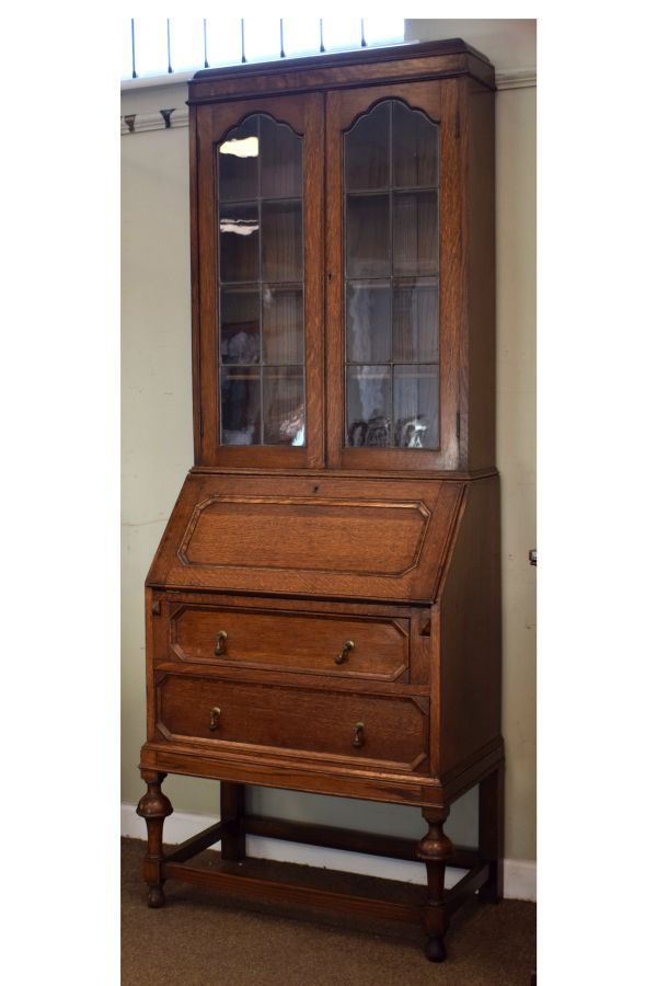 1920's period oak two section bureau bookcase, the upper section fitted four shelves enclosed by a