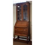 1920's period oak two section bureau bookcase, the upper section fitted four shelves enclosed by a