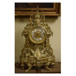 Early 20th Century cast brass cased mantel clock elaborately decorated with gryphon, mask heads