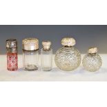 Five assorted cut glass toiletry jars to include; a ruby-flashed example, two clear spherical