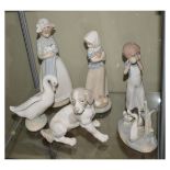 Group of five Nao Spanish porcelain figurines comprising: two young girls, each with puppy, figure