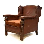Early 20th Century hide-covered club-style easy chair with studded decoration and oak show frame