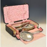 Late Victorian cased five piece dressing set comprising: hand mirror, pair of hand brushes and