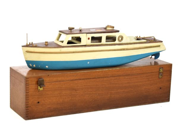 Vintage steam-powered scale model of a river cruiser with wooden cabin and deck enclosing spirit-