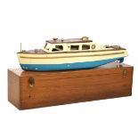 Vintage steam-powered scale model of a river cruiser with wooden cabin and deck enclosing spirit-