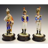 Three Kaiser porcelain figures of soldiers, each in traditional historical military uniform on