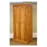 20th Century yellow pine wardrobe having a pair of twin fielded panelled doors enclosing a hanging