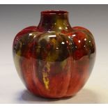 Royal Doulton Flambé lobed vase having mottled polychrome decoration on a red ground, printed