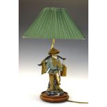 Japanese pottery figural table lamp modelled as a fisherman with catch, beneath a pleated shade