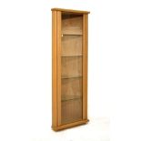 Modern floor-standing light oak corner cabinet enclosing four glass shelves Condition: