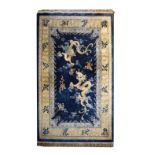 Chinese rug, the central field decorated with dragons chasing flaming pearls over waves on a blue