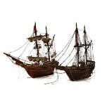 Two wooden models of tall-masted sailing ships or galleons, each fully-rigged, each approximately