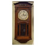 Early 20th Century stained oak wall clock having a two-train movement and silvered Arabic dial