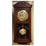Early 20th Century stained oak wall clock having a two-train movement and silvered Arabic dial