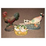 Three various painted cast iron doorstops modelled as a pheasant, cockerel and ducks respectively (