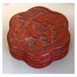 Chinese cinnabar lacquer floret shaped box and cover decorated with figures in a landscape