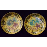 Pair of Chinese saucer dishes, each decorated with a dragon and phoenix on a yellow ground,