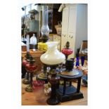 Group of assorted paraffin lamps to include; French style cast figural example with cranberry