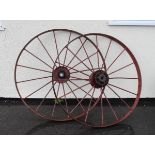 Pair of early 20th Century red-painted iron cartwheels, each of eight-spoke design, 107cm diameter