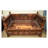 Eastern iron-mounted wooden day bed or box seat, with panelled back and strapwork decoration over
